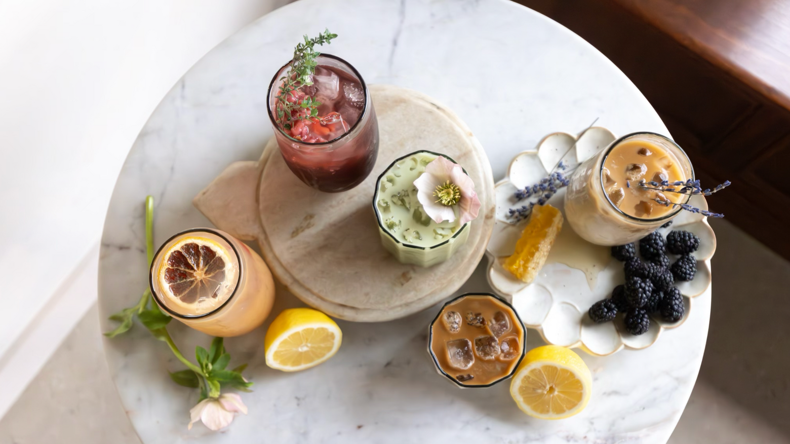 Assorted beverages with garnishes on a marble table